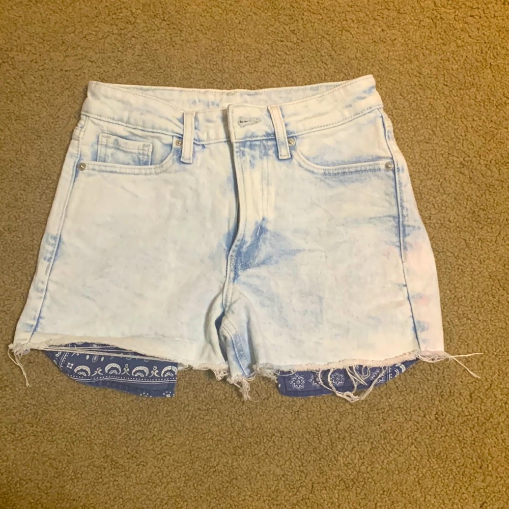Shorts with patterned pocket showing
